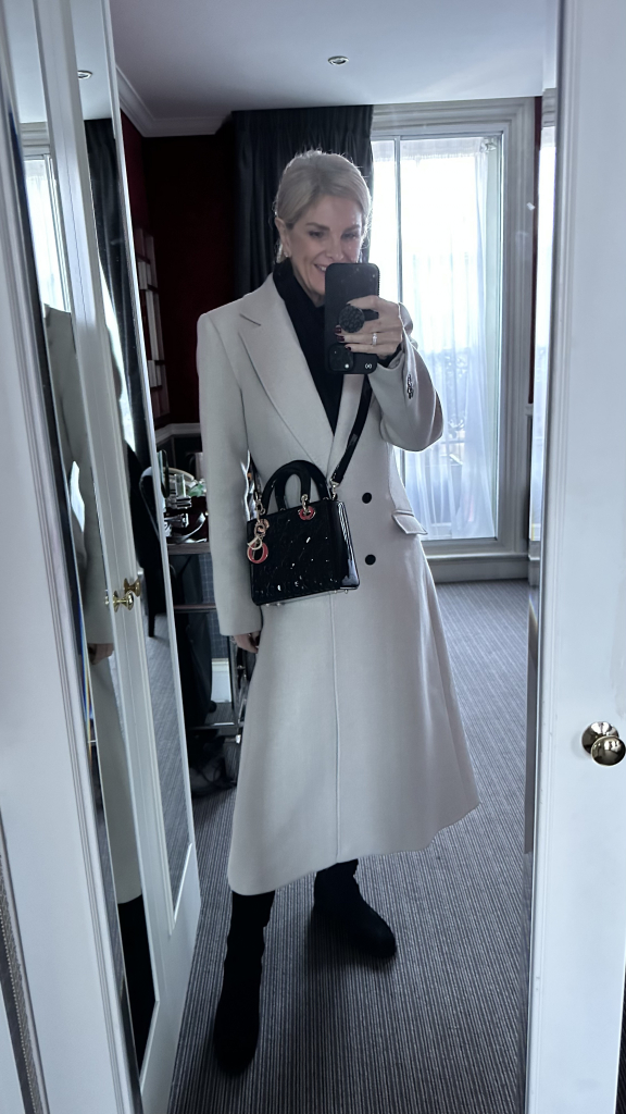 Tanya Foster wearing a gray coat and small dior handbag